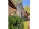 Exterior building with wood and stone detail; lush greenery in front at 560 Brook Manor Dr, Johns Creek, GA 30022