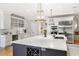 Bright kitchen features custom white cabinets, marble countertops, stainless steel appliances, and stylish lighting at 560 Brook Manor Dr, Johns Creek, GA 30022