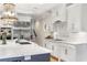 Bright kitchen features custom white cabinets, marble countertops, stainless steel appliances, and stylish lighting at 560 Brook Manor Dr, Johns Creek, GA 30022
