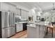 Open-concept kitchen area featuring stainless steel appliances, marble counters and wood floors at 560 Brook Manor Dr, Johns Creek, GA 30022