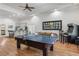 Open concept living area featuring a kitchen and sofa seating with a pool table and arcade game at 560 Brook Manor Dr, Johns Creek, GA 30022