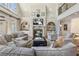 Inviting living room with fireplace, built-in shelving, and comfortable seating, designed for relaxation and socializing at 560 Brook Manor Dr, Johns Creek, GA 30022