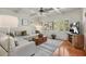 Comfortable living room with a large sectional sofa, coffered ceiling, and plenty of natural light at 560 Brook Manor Dr, Johns Creek, GA 30022