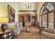 Cozy living room with a large arched window, wooden shelves and beams, and comfortable seating arrangement at 560 Brook Manor Dr, Johns Creek, GA 30022