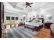 Spacious main bedroom with trey ceilings, hardwood floors, and windows that let in natural light at 560 Brook Manor Dr, Johns Creek, GA 30022