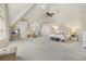 Spacious bedroom with neutral carpet, ceiling fan, and windows for plenty of natural light at 560 Brook Manor Dr, Johns Creek, GA 30022