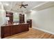 Office with a built-in desk, hardwood floors, and book shelves at 560 Brook Manor Dr, Johns Creek, GA 30022