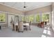 Spacious sunroom with many windows, a ceiling fan and dining and sitting area at 560 Brook Manor Dr, Johns Creek, GA 30022
