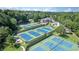Overhead view of the community tennis courts near the pool and stately brick clubhouse at 560 Brook Manor Dr, Johns Creek, GA 30022