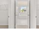 Open door to bathroom featuring white tile, a soaking tub, and a window at 7162 Linden Dr, South Fulton, GA 30349