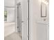 View of bathroom vanity from open door featuring white countertops, and bright lighting fixtures at 7162 Linden Dr, South Fulton, GA 30349