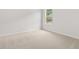 This bedroom is bright with neutral paint, plush carpet, and a large window at 7162 Linden Dr, South Fulton, GA 30349