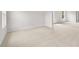 Open bedroom featuring neutral carpet, bright white walls, and natural light from the large windows at 7162 Linden Dr, South Fulton, GA 30349