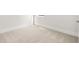 An empty bedroom with light-colored carpet, white walls, and white trim offers a blank canvas ready to be personalized at 7162 Linden Dr, South Fulton, GA 30349