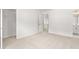 Neutral bedroom featuring neutral carpet, walk-in closet, and entrance to bathroom at 7162 Linden Dr, South Fulton, GA 30349