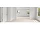 Hallway with neutral carpet leading to additional bedrooms with light from the windows at 7162 Linden Dr, South Fulton, GA 30349