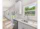 Well-lit kitchen featuring white cabinets, stainless steel appliances, and modern countertops at 7162 Linden Dr, South Fulton, GA 30349