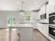 Elegant kitchen featuring white cabinets, stainless steel appliances, and a center island at 7162 Linden Dr, South Fulton, GA 30349