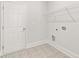 A bright laundry room with patterned tile flooring and a wire shelf at 7162 Linden Dr, South Fulton, GA 30349