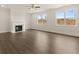 Bright living room features a fireplace, hardwood floors, and large windows at 7162 Linden Dr, South Fulton, GA 30349