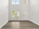 Bright living room with high ceilings, large windows, and stylish gray wood flooring at 7162 Linden Dr, South Fulton, GA 30349