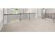 Bright loft space featuring neutral carpet, black iron balusters, and natural light from the windows at 7162 Linden Dr, South Fulton, GA 30349