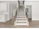 A classic staircase with wooden treads and white risers offers a view of the open-concept design at 7162 Linden Dr, South Fulton, GA 30349