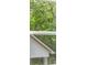 A window view showcases lush greenery with a glimpse of the white siding and angled roofline of an adjacent home at 7162 Linden Dr, South Fulton, GA 30349