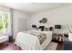 Cozy bedroom featuring a comfortable bed with stylish bedding, a large window with natural light, and trendy decorations at 1984 Yellow Finch Se Trl, Atlanta, GA 30316
