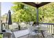 A covered deck complete with a grill, seating, and a view of the surrounding landscape at 1984 Yellow Finch Se Trl, Atlanta, GA 30316