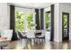 Bright dining room area with large windows, shiplap walls, modern lighting and stylish decor at 1984 Yellow Finch Se Trl, Atlanta, GA 30316