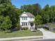 Beautiful two-story home featuring a well-maintained lawn, mature trees, and a paved driveway in a serene neighborhood at 1984 Yellow Finch Se Trl, Atlanta, GA 30316
