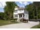 Charming two-story home with white siding, well-manicured lawn, mature trees, and a paved driveway at 1984 Yellow Finch Se Trl, Atlanta, GA 30316
