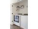 A well-organized laundry closet with modern washer and dryer units, and wire shelving for storage at 1984 Yellow Finch Se Trl, Atlanta, GA 30316