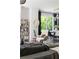 Stylish living space with modern decor, including an accent chair, bookshelf, and dining area in natural light at 1984 Yellow Finch Se Trl, Atlanta, GA 30316