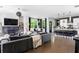 Open-concept living room features a modern fireplace, sleek furnishings, and a seamless flow to the kitchen at 1984 Yellow Finch Se Trl, Atlanta, GA 30316