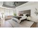 Relaxing main bedroom with a tray ceiling, ceiling fan, plush king bed, and bright windows with cozy seating at 1984 Yellow Finch Se Trl, Atlanta, GA 30316