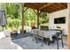 Charming outdoor patio featuring stone pavers, comfortable seating, a dining area, and views of a lush backyard at 1984 Yellow Finch Se Trl, Atlanta, GA 30316