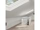 Finished attic space features skylights, carpeting, and stairs with white railing at 3915 Ivy Ne Rd, Atlanta, GA 30342