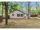 Wide backyard featuring mature trees, freshly laid sod, and a wood privacy fence at 3915 Ivy Ne Rd, Atlanta, GA 30342