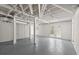 Spacious unfinished basement with painted brick walls, exposed beams, and a walkout to the backyard at 3915 Ivy Ne Rd, Atlanta, GA 30342
