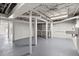 Large unfinished basement featuring exposed support beams, shelving, and a utility sink at 3915 Ivy Ne Rd, Atlanta, GA 30342