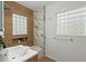 Beautiful bathroom featuring a glass block window and marble accent wall at 3915 Ivy Ne Rd, Atlanta, GA 30342