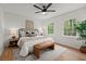 Comfortable bedroom with natural light, hardwood floors, a ceiling fan, and a cozy queen-sized bed at 3915 Ivy Ne Rd, Atlanta, GA 30342