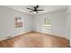 Sun-filled bedroom featuring hardwood floors, ceiling fan, and double windows at 3915 Ivy Ne Rd, Atlanta, GA 30342