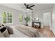 Serene bedroom filled with natural light from large windows, hardwood floors, with modern decor and a cozy feel at 3915 Ivy Ne Rd, Atlanta, GA 30342