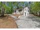 Two-story home featuring a brick exterior, a concrete driveway, and mature trees in the front yard at 3915 Ivy Ne Rd, Atlanta, GA 30342