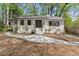 Charming brick home featuring a landscaped front yard, updated windows and inviting entryway steps at 3915 Ivy Ne Rd, Atlanta, GA 30342