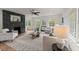 Bright living room featuring neutral paint, fireplace with stone surround, and hardwood flooring at 3915 Ivy Ne Rd, Atlanta, GA 30342