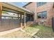 Brick home featuring a covered outdoor walkway, a small yard, and a private fence at 683 Pryor Sw St # C, Atlanta, GA 30315